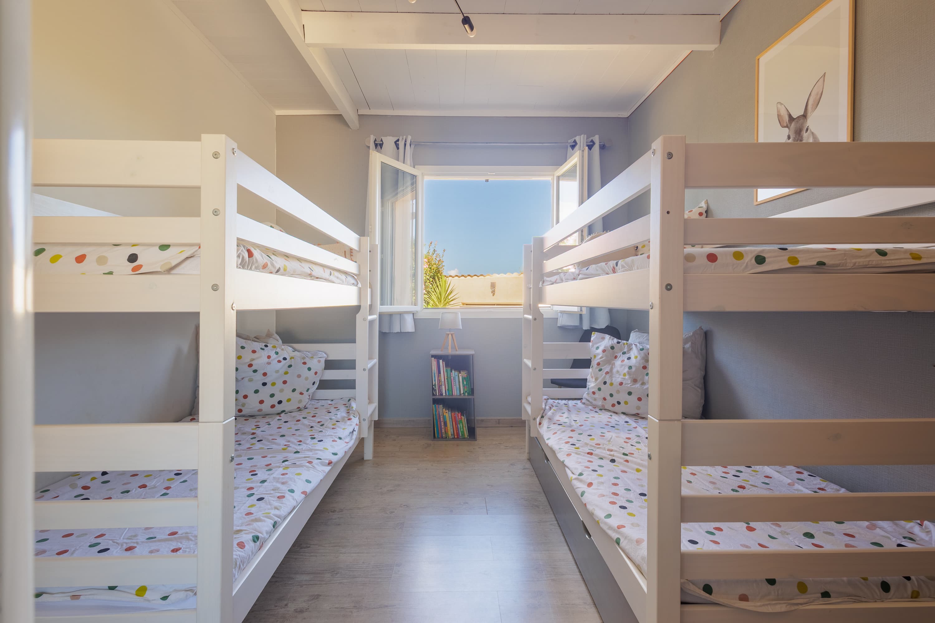 Chambre enfants avec deux lits superposés et coin lecture